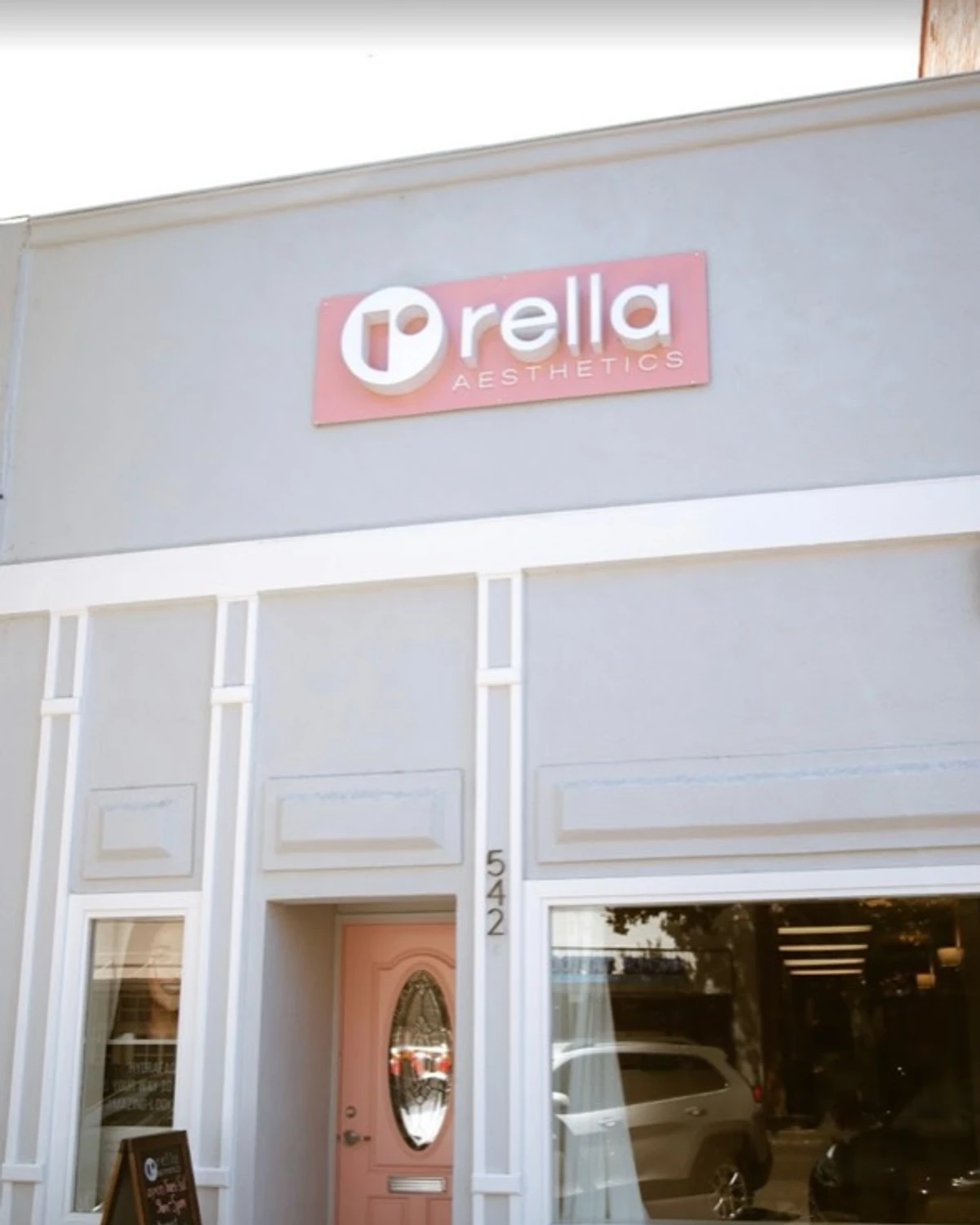 The Rella Aesthetics storefront and pink entrance at the Vacaville clinic